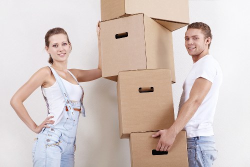 Professional movers carrying furniture during a Ladbroke Grove relocation
