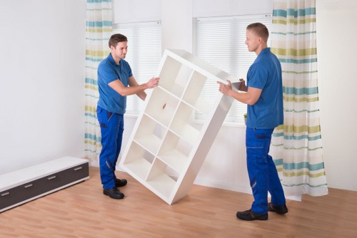Experienced movers organizing fragile household items during packing services in Ladbrokegrove